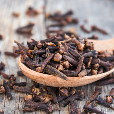 Cut up clove in a wooden spoon