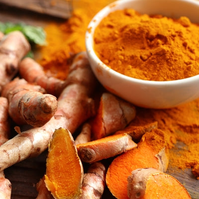 Turmeric cut up and grinded in a bowl