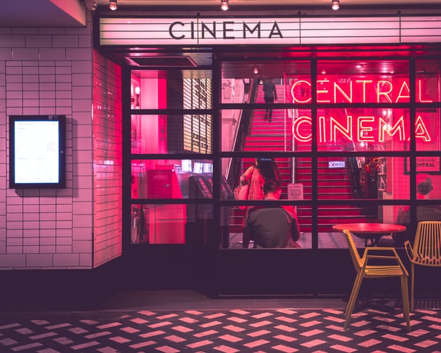 The front of a cinema with an illuminated sign that says “Central cinema”