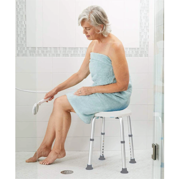 Image of an elderly woman sitting on the Carex shower stool