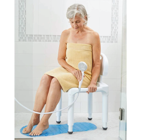 An elderly woman sitting on the Carex Universal Bath Seat 