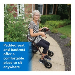 Elderly woman using ProBasics Rollator. Text: Padded seat and backrest offer a comfortable place to sit anywhere.