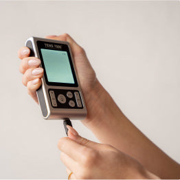 The TENS 7000 Rechargeable TENS Unit being plugged in