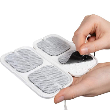 The TENS 7000 TENS Unit Pad Holder with electrodes in it being pulled on a white background