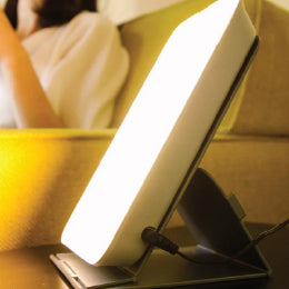 A close-up of the theralite energy lamp on a coffee table