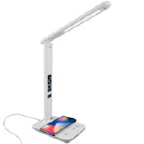 TheraA white therapy lamp with a long face and cell phone charging on itLite Radiance