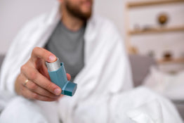 A man holding an inhaler for asthma