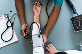 A doctor checking a person’s blood pressure