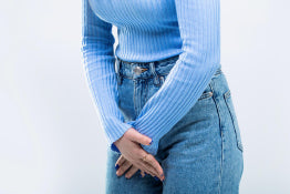 A woman holding her bladder in pain