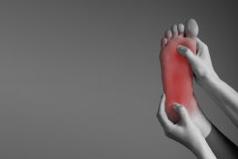A foot being held with red showing pain