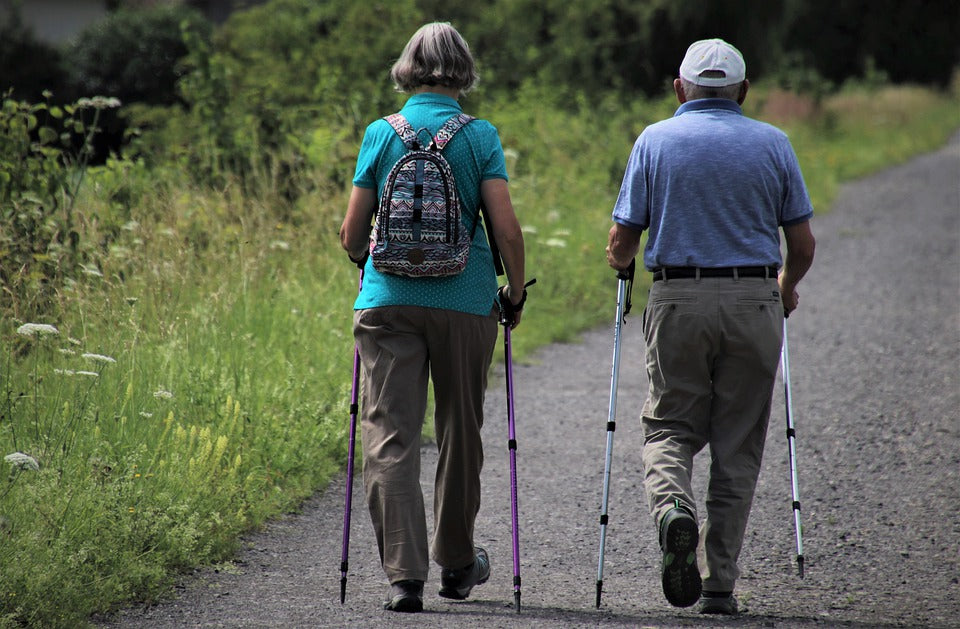 A senior couple hiking with hiking sticks