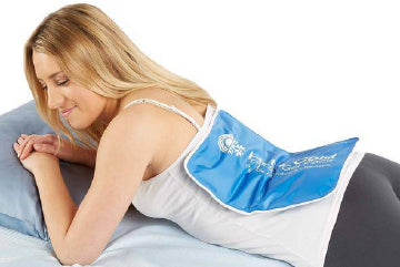 A woman lying on her stomach using a hot/cold wrap on her back