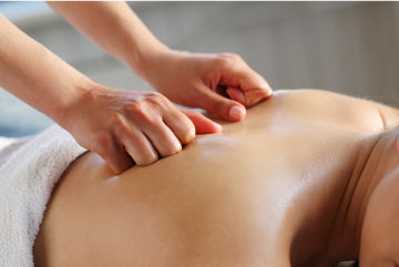 A massage therapist massaging a person’s back