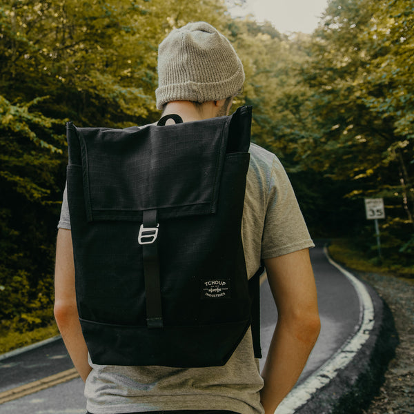 Person wearing black back pack outdoors