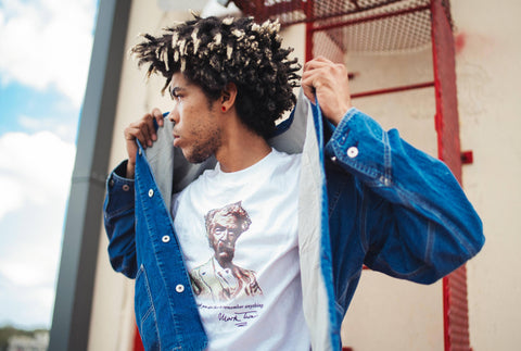 A young man sporting a t-shirt with an image and quote from Mark Twain, demonstrating how easy it is to use clothing to promote political fashion trends.