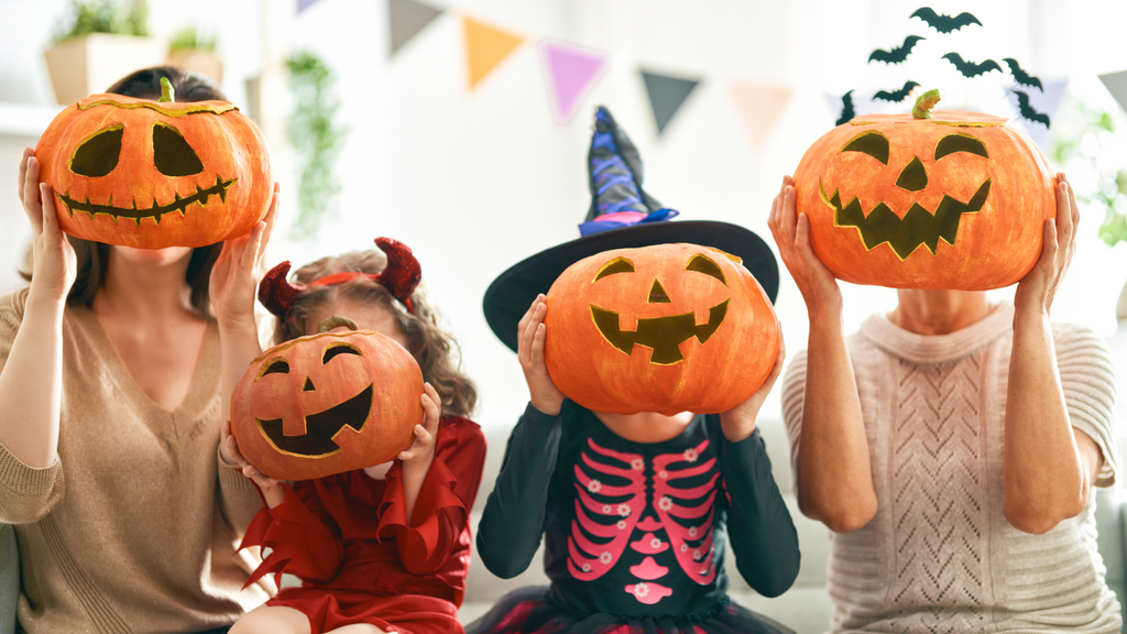 Kids celebrate Halloween with decorated pumpkins