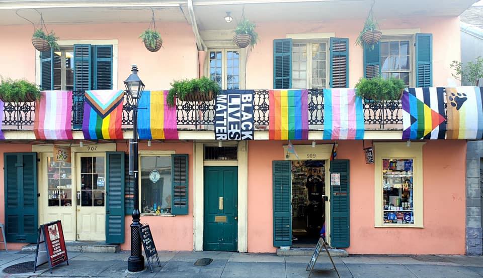 A French Quarter storefront with colorful flags