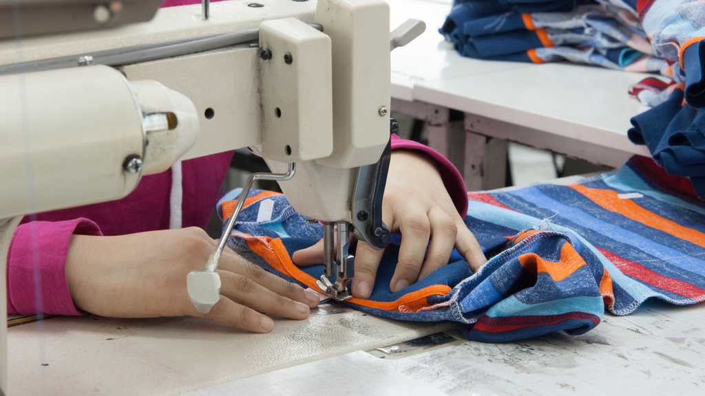 A woman works at a sewing machine