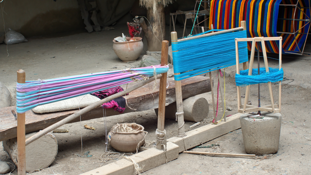 Ikat print yarn is wound around cones before weaving