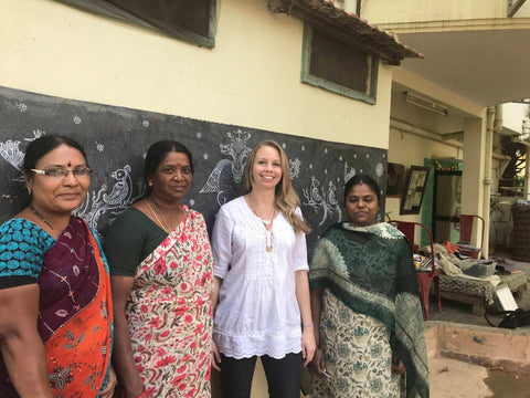 A photo of Passion Lilie's founder and designer, Katie Schmidt, with three Indian artisans we work with to make fair trade, ethical clothing online.