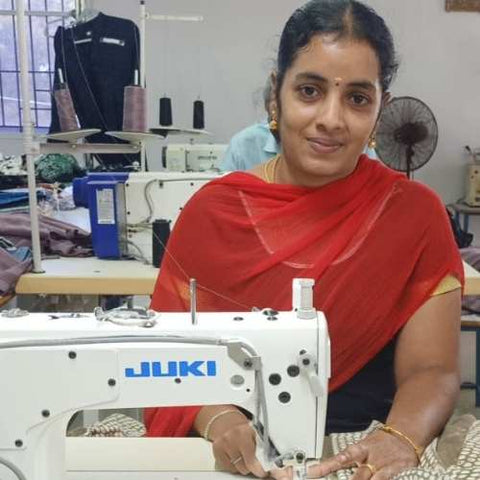 Our trainee, Jayanthi, works at her sewing machine.