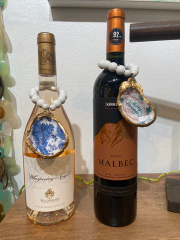 Oyster ornaments decorate wine bottles for perfect host gifts