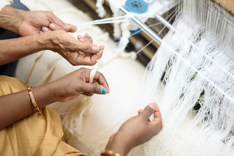 Artisans hand weaving garments