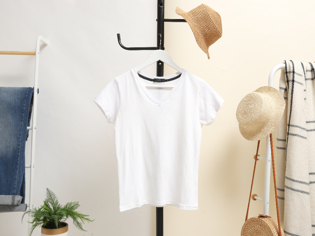 White t-shirt hangs on coat rack