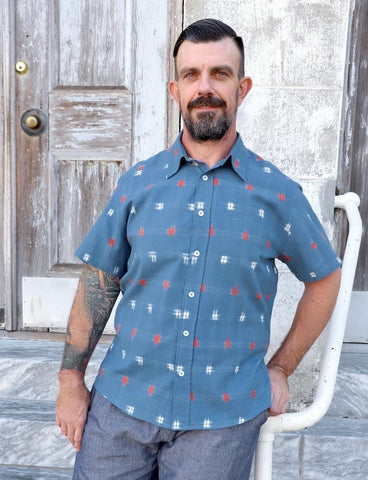 Man wears Passion Lilie blue button down shirt