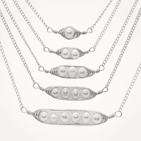 Silver necklaces with pearls made to look like pea pods