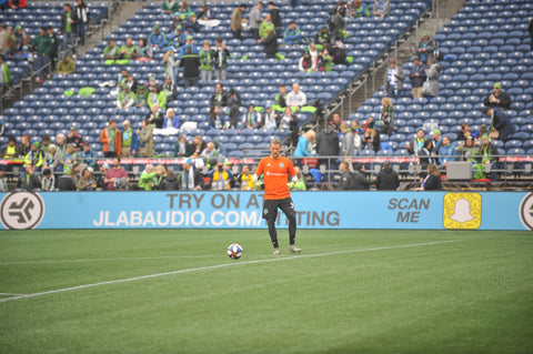 JLab Audio ad behind soccer player on field