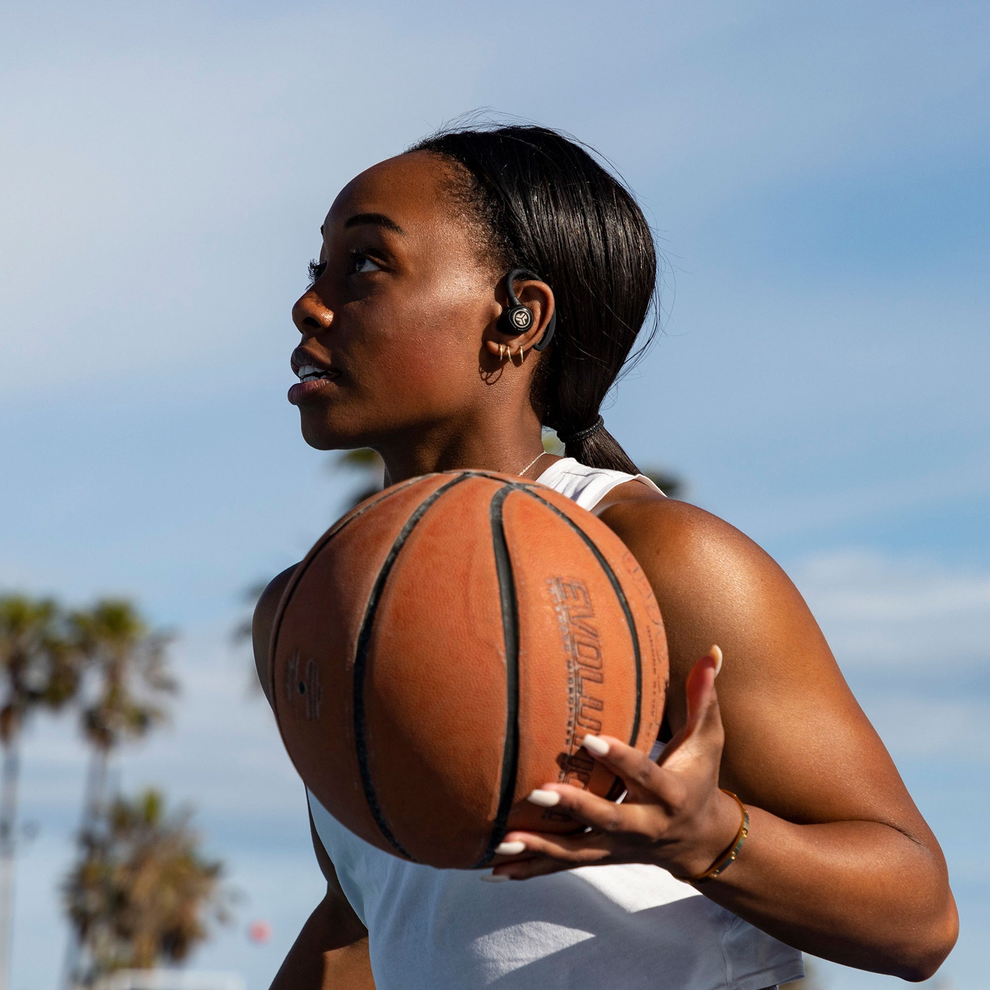 Woman Playing Basketball Wearing Epic Air Sport True Wireless Earbuds