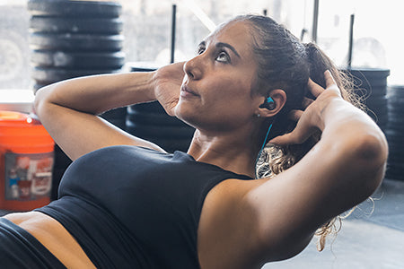 Girl wearing Fit Sport 3 Wireless Fitness Earbuds