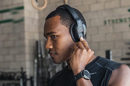 Man Adjusting Controls on Flex Sport Headphone