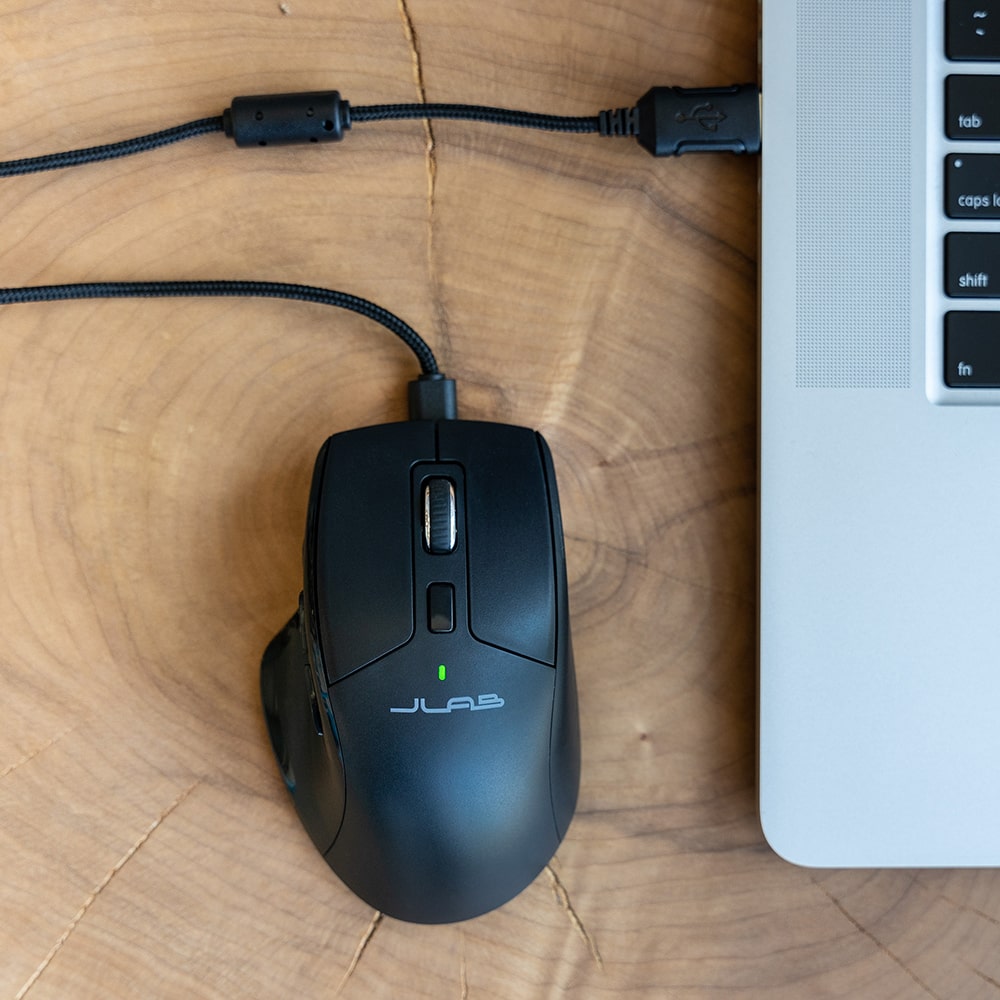 JBuds Mouse with rechargeable battery plugged into a laptop