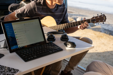 Man With Guitar and Go Work Setup