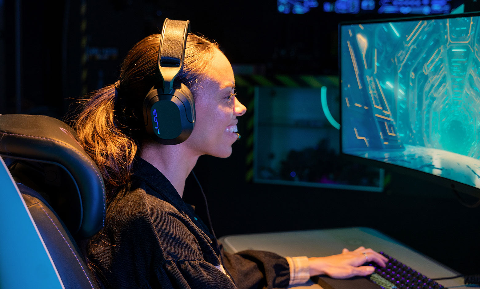 Girl playing a game with JLab Nightfall Gaming headset