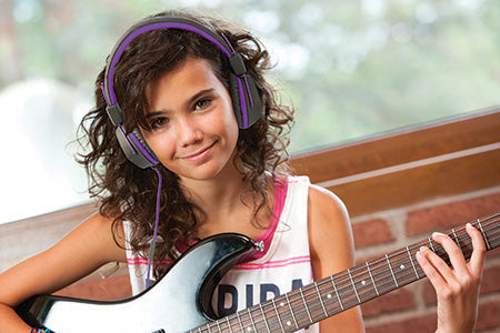 Girl wearing JBuddies Studio On-Ear Folding Headphones in Purple