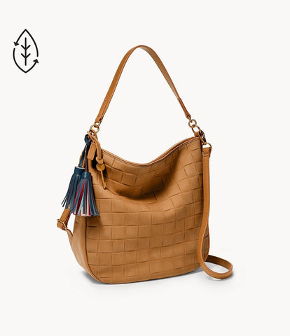 A slouching brown bag appearing suede-like with a short handle and a longer crossbody handle behind it.