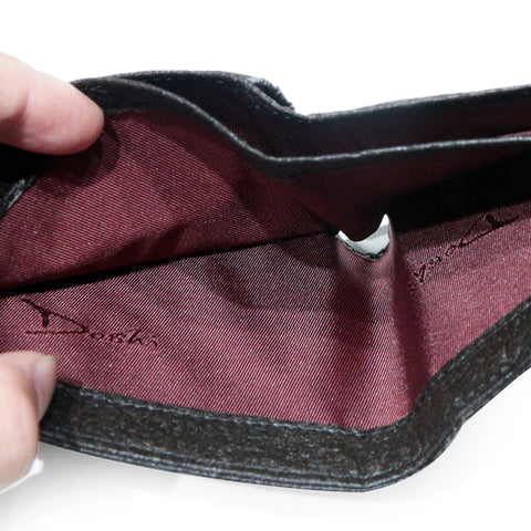 A black bifold wallet opened to reveal a burgandy liner.