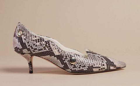 A snake skin shoe with a pointed toe and a short, tapered heel.