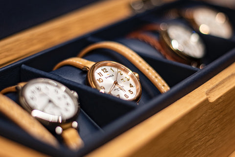 A series of luxury watches in a wooden case