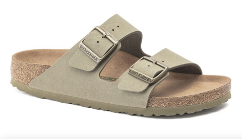 A tan two-strap sandle with a cork insole and silver buckles.