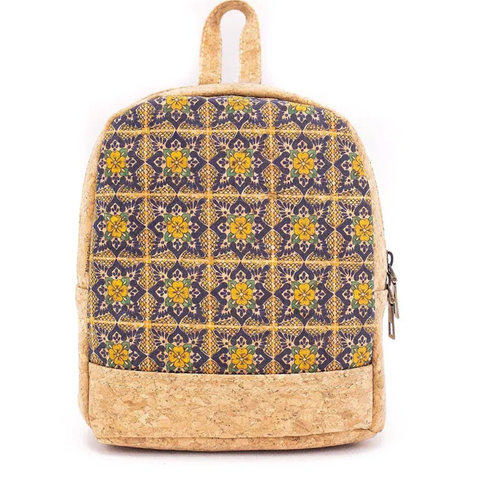 A bright tan backpack with a yellow and blue geometric flower design on the front.