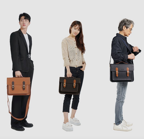 Three people - a man in a suit, a woman in jeans and a sweater, and an older man in light jeans and a dark shirt - carrying satchel bags in various colors.