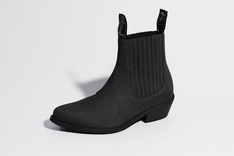 A black suede ankle boot with ribbing along the ankle.