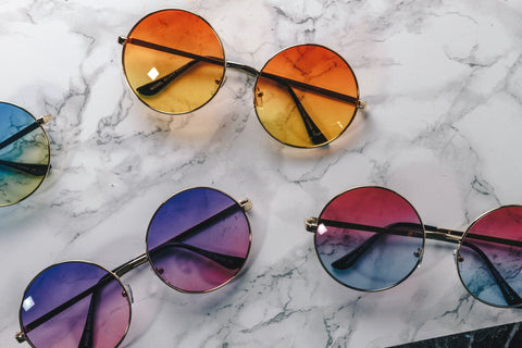 Various round-rimmed gradient colored sunglasses.