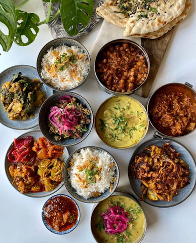 A circular arrangement of vegan Indian dishes.