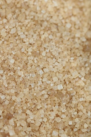 A close image of unbleached sugar crystals.