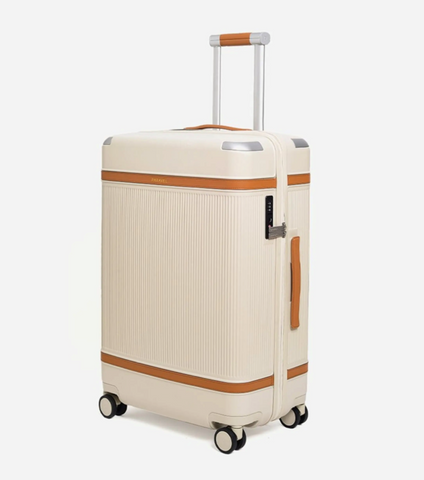 A standing white suitcase with two brown accent stripes and castor wheels.